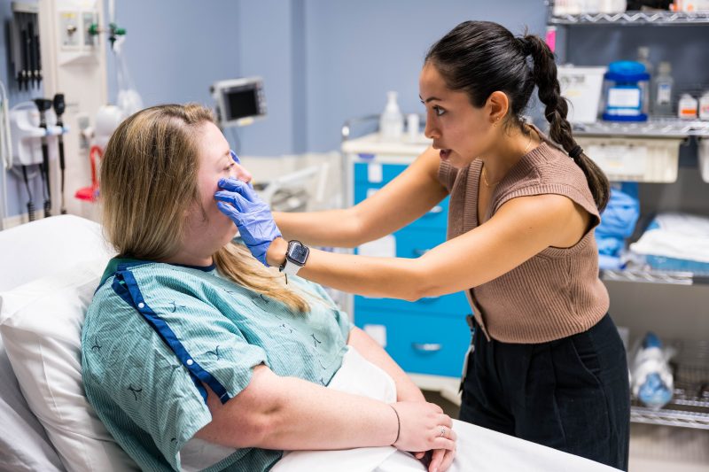 A Virginia Tech MSND students performs a diagnostic test on a patient.